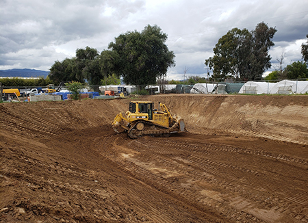 Photo Of An Edmondson Construction CAT D6R Dozer With Slope Board Moving Dirt At The Jobsite