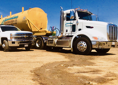 Photo Of An Edmondson Construction Tractor Pulling A Water Tanker And A Chevrolet F350 HD Work Truck